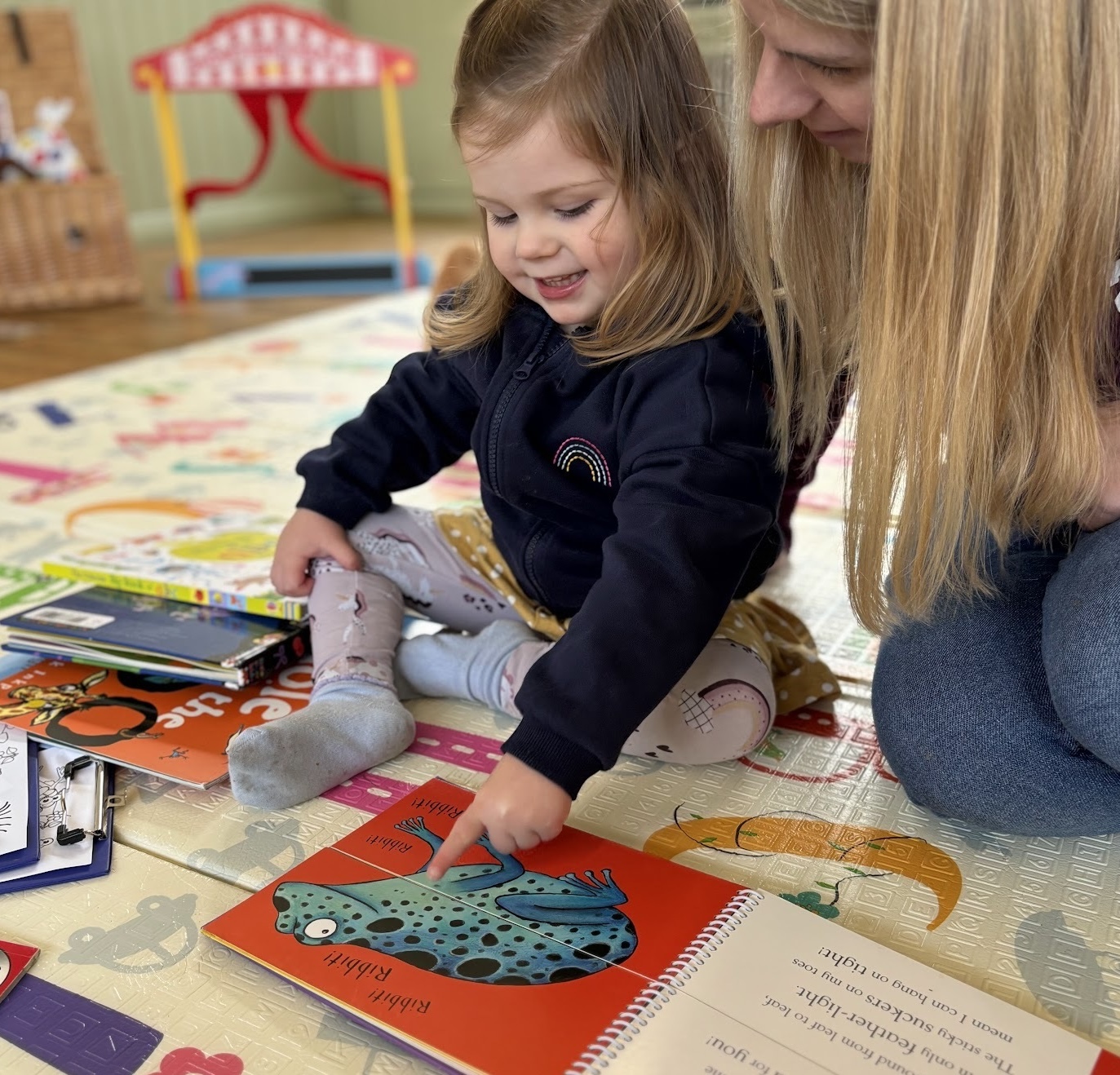 Parent and child reading together at Happy Little Adventurers